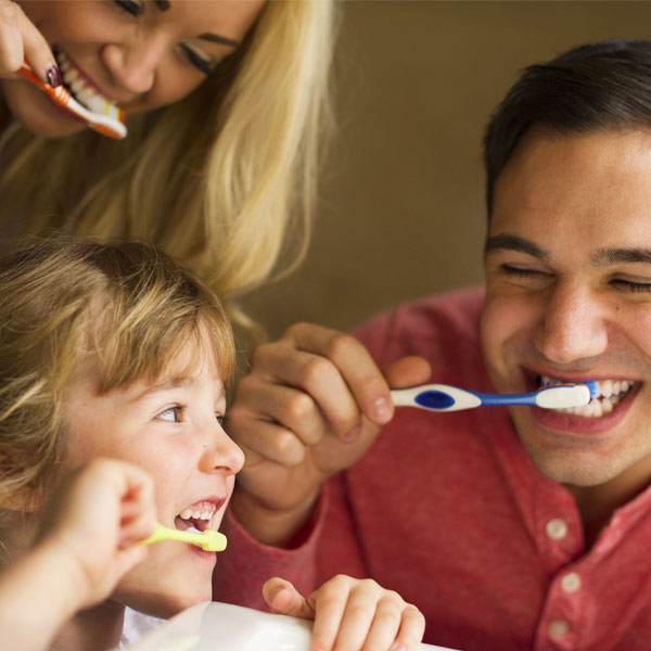 family brushing teeth